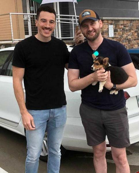 Mark andh Neill with their newly adopted Pembroke Welsh Corgi puppy from Bar H Farms in Missouri.